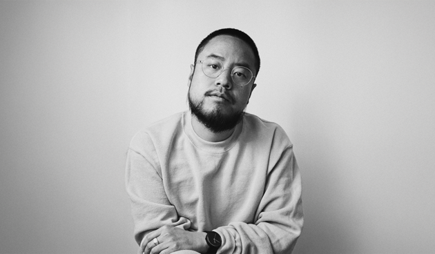 Black and white portrait of a man looking directly at the camera.